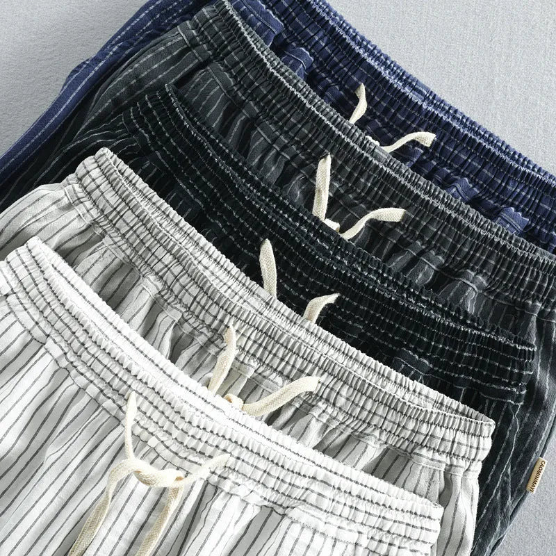 Men's striped casual shorts in a loose straight-leg style on a plain background.