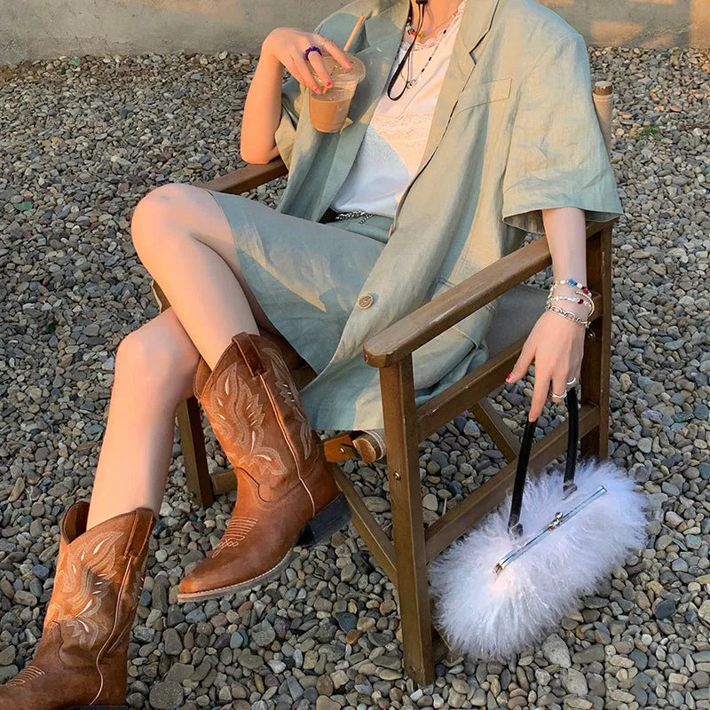 Brown women's embroidered Martin boots with mid-calf length, leather lining, and waterproof platform