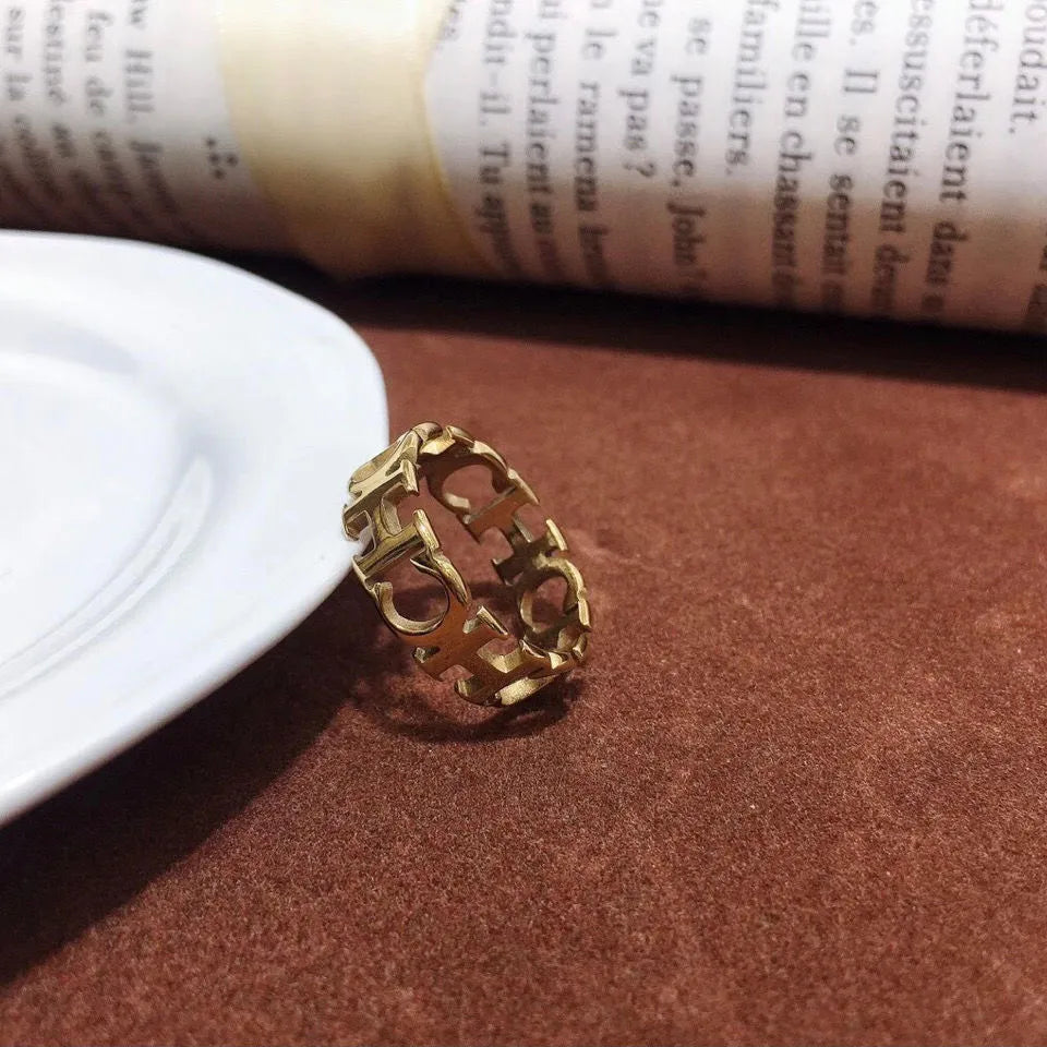 Gold titanium steel unisex letter ring with hollowed cut design, sizes 6 to 9