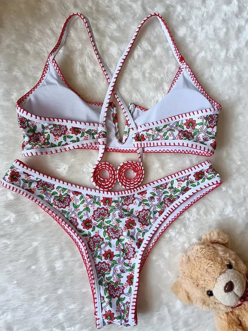 Women's V-neck swimsuit with embroidered detail and floral printed pattern in briefs style