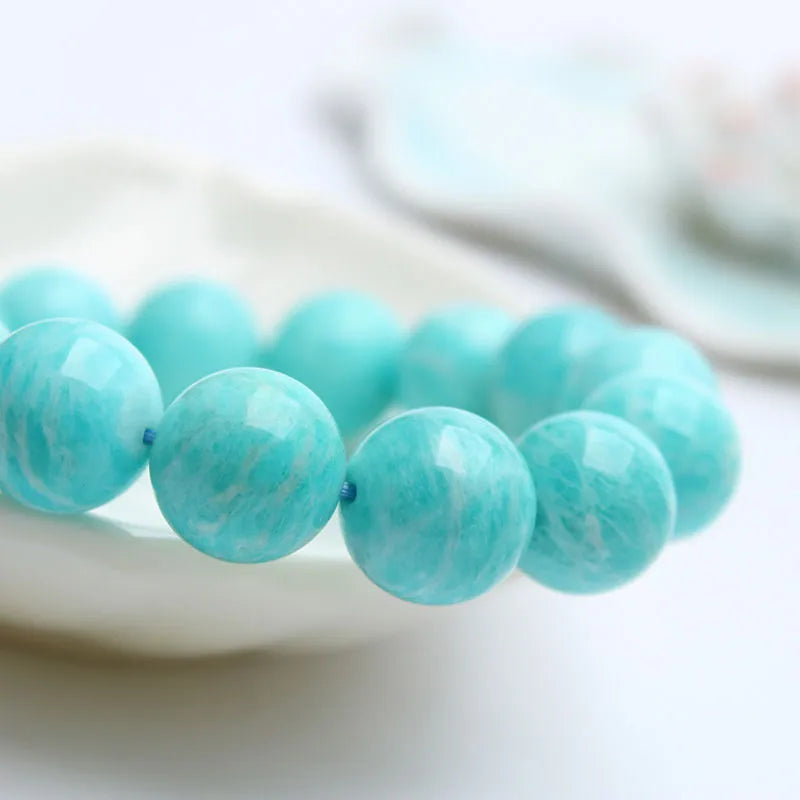 Natural blue-green Amazonite gemstone bracelet with adjustable closure on a wrist.