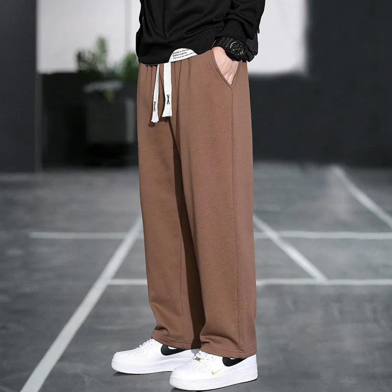 Men's grey Ninth Sports Pants showing high waist and multiple pockets.