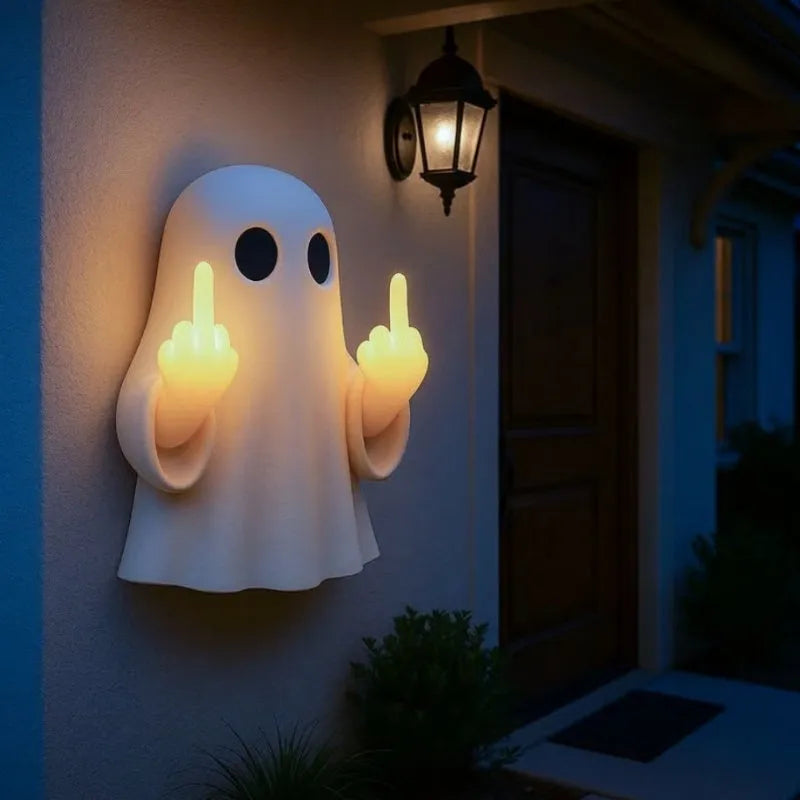 White plastic ghost statue night lamp for Halloween decoration on a dark surface.