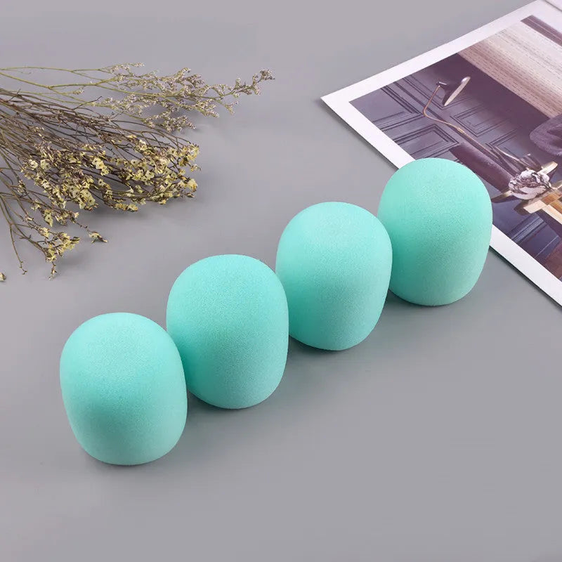 Four multicoloured foam microphone windshields for handheld stage microphones