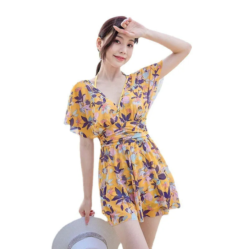 Yellow floral pattern women's one-piece polyester swimsuit on mannequin