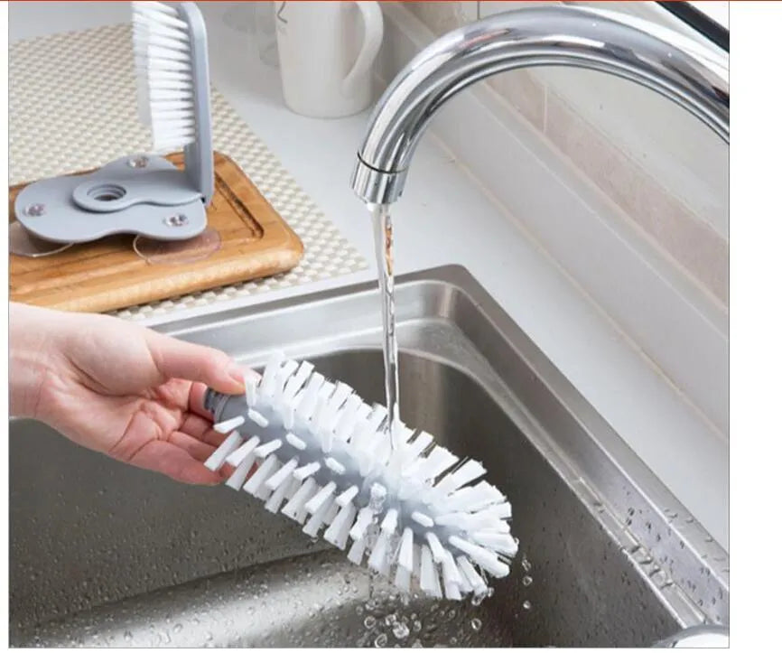 Grey rotating cup brush with dual heads and suction cups for wall mounting