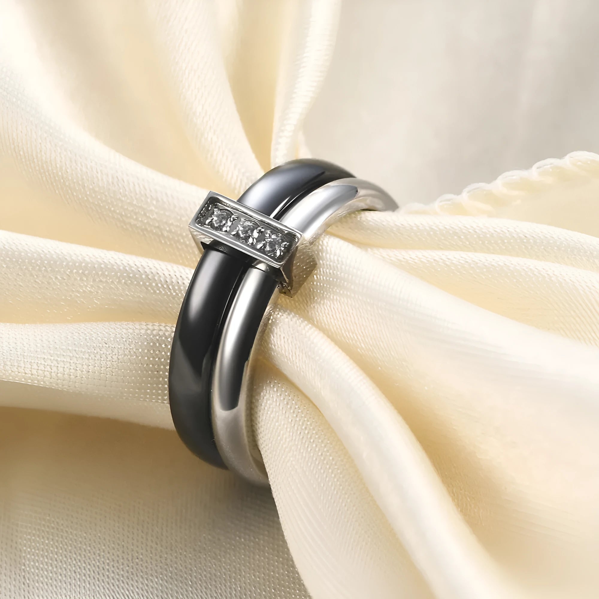Glossy black geometric ceramic ring with a 6mm wide band on a woman's finger.