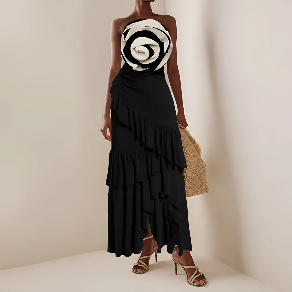 Women's black and white one-piece swimsuit with a detachable matching skirt on a beach.