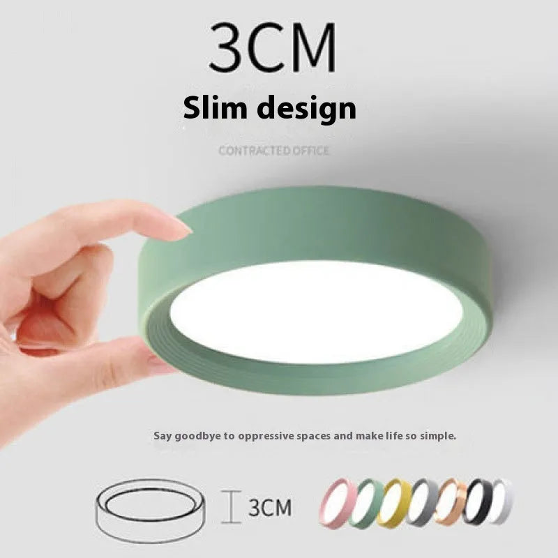 Ultra-thin surface mounted LED downlight in a choice of seven shell colours including black, white, gold, and pink.