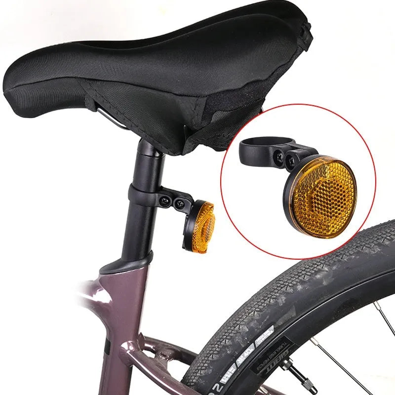Plastic bicycle taillight with anti-theft bracket mounted on seat post showing red reflective panel