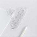 Square plastic photo memo holder in black, white, or transparent on a desk.