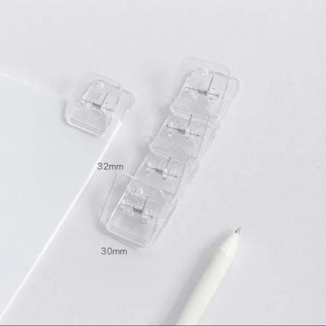 Square plastic photo memo holder in black, white, or transparent on a desk.