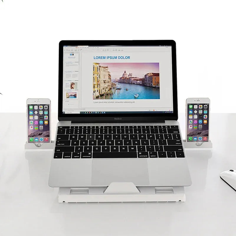Black folding aluminium laptop stand with 9-level angle adjustment and cooling slot, on a desk with a laptop