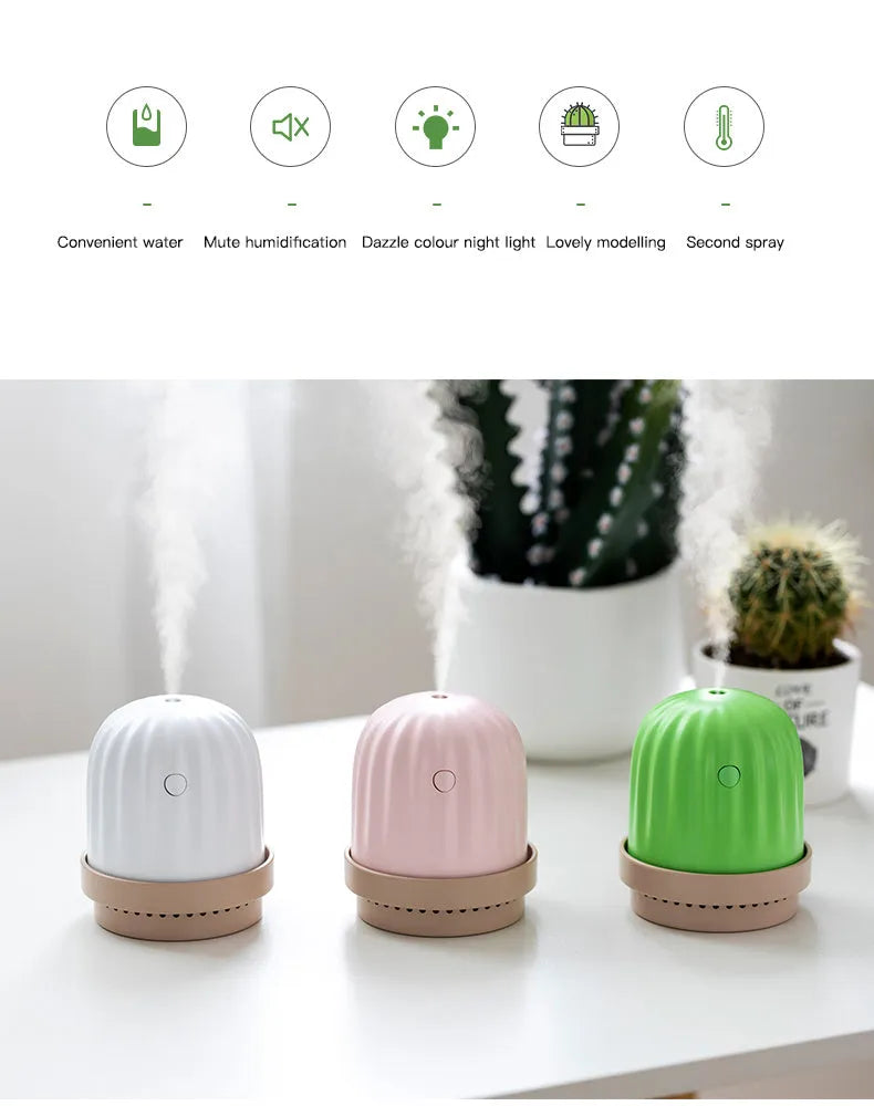 Cactus humidifier night light in green with colourful LED glow on a wooden desk