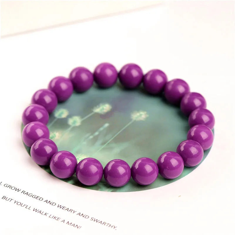 Purple mica crystal bracelet with polished beads, shown in unisex design.