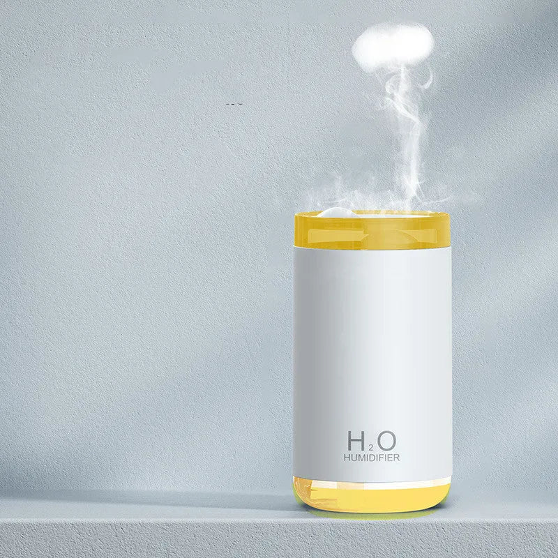 White USB jellyfish humidifier with night light on a wooden desk