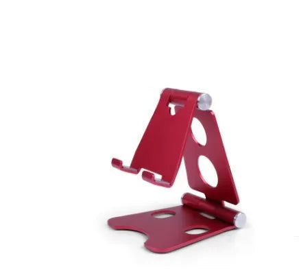 Folding mini mobile phone bracket in black with foldable legs, on a wooden desktop