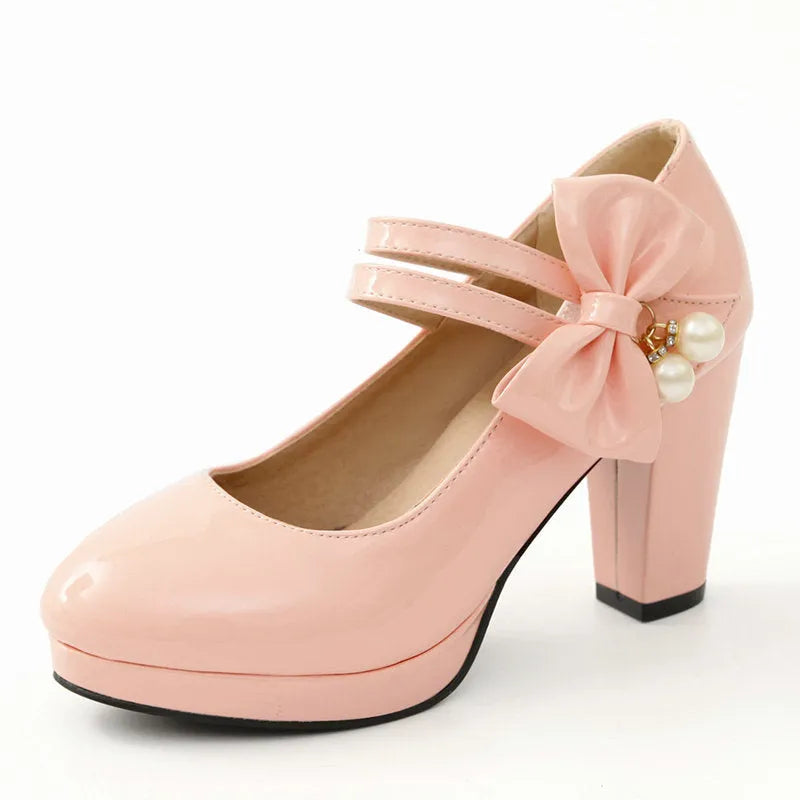 Red platform shoes with a thick chunky heel, round toe, and buckle fastening on a white background.