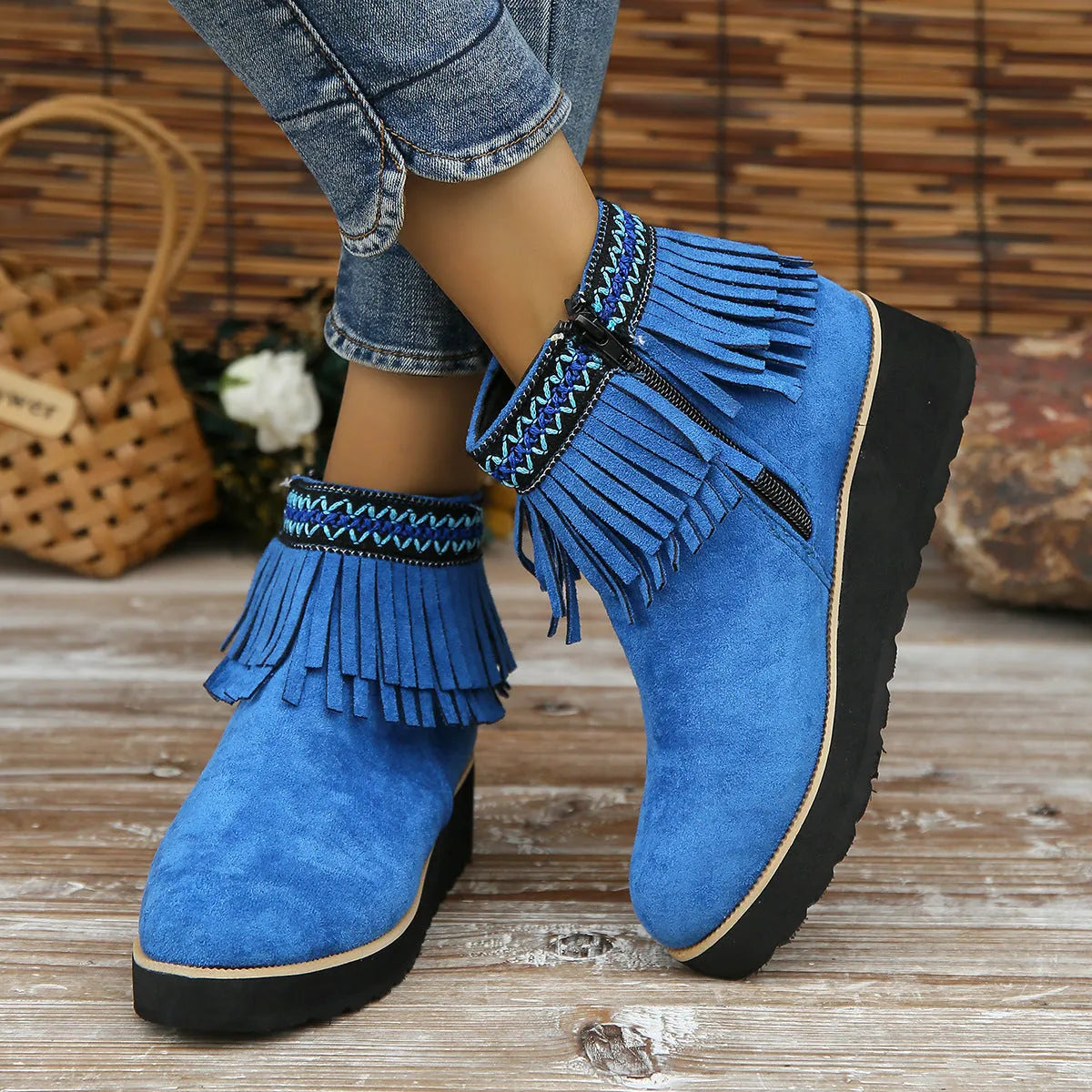 Women's dark brown suede wedge ankle boots with a tassel and side zipper on a thick rubber sole.