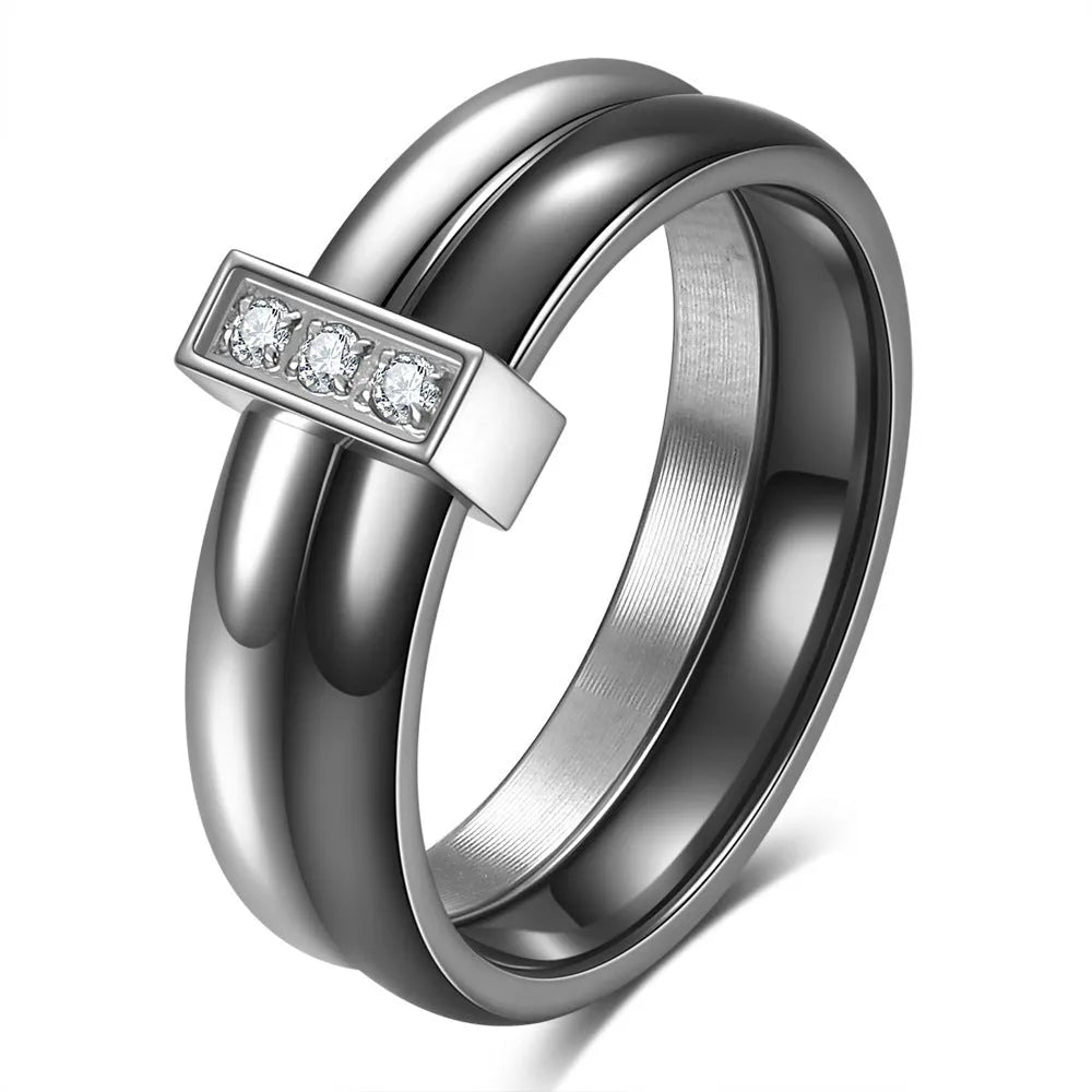 Glossy black geometric ceramic ring with a 6mm wide band on a woman's finger.