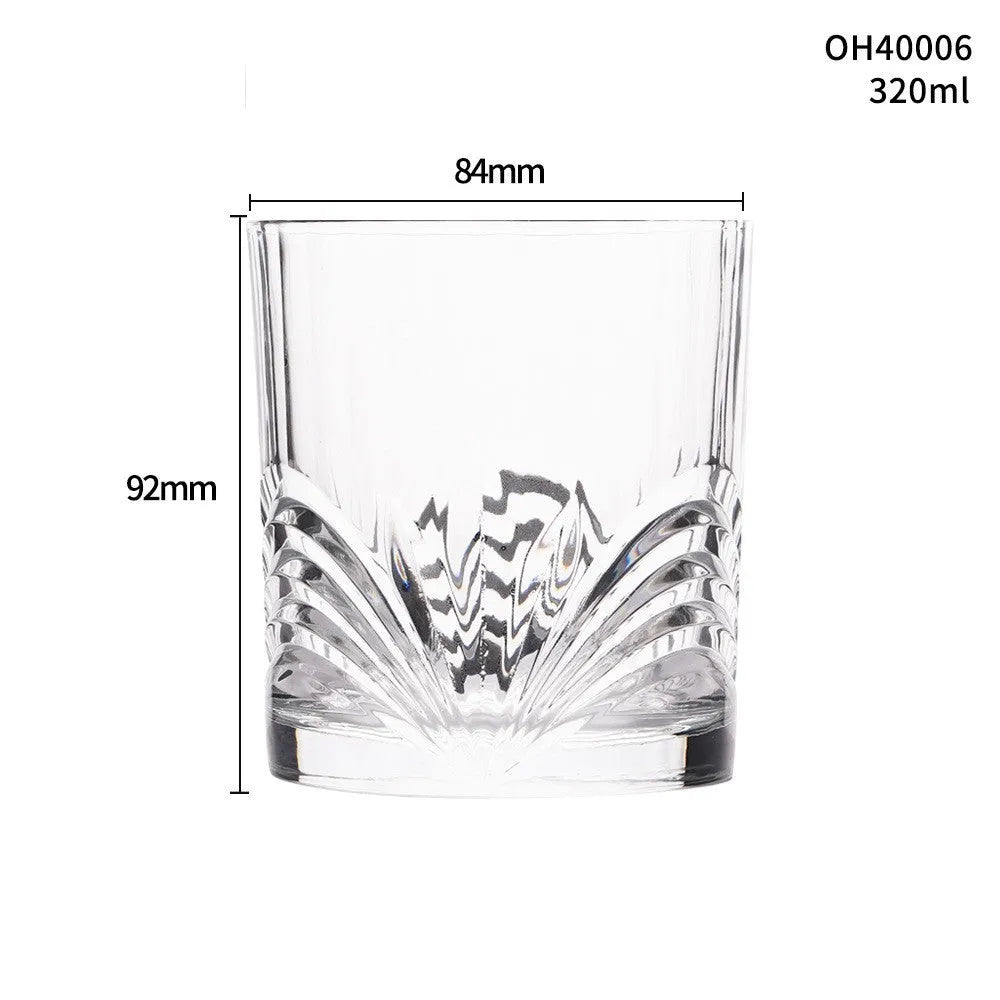 Clear crystal whiskey shot glass with thick bottom base on a table.