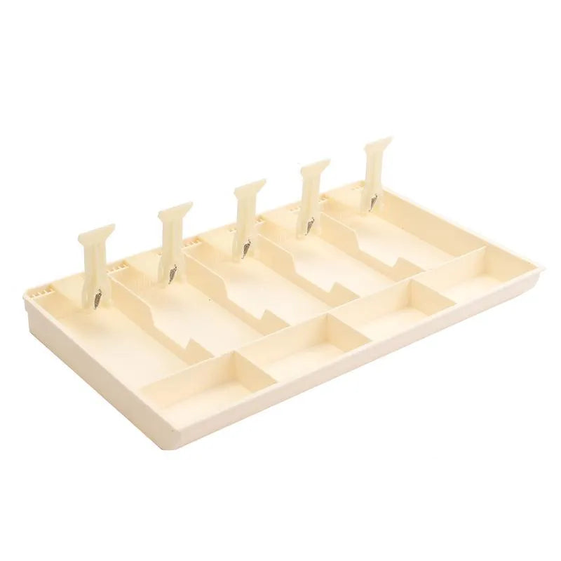 Black and white ABS plastic cash register box with five drawers for banknotes and coins.