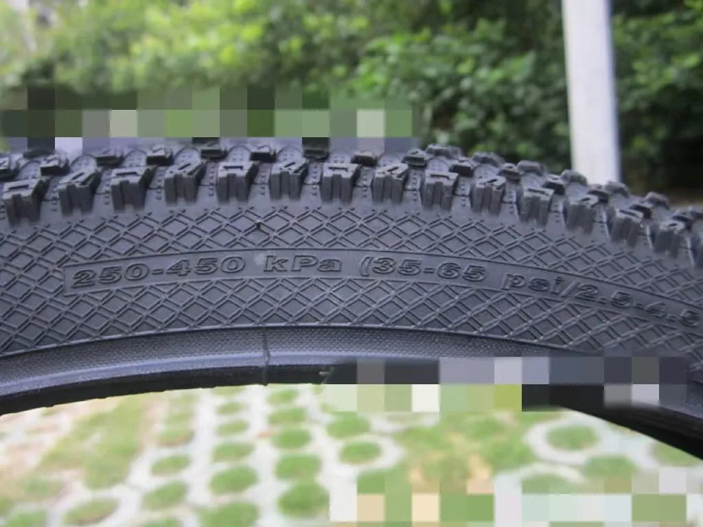 Mountain bike tyre with tread, shown in multiple size options: 26, 27.5 and 29 inch diameters.