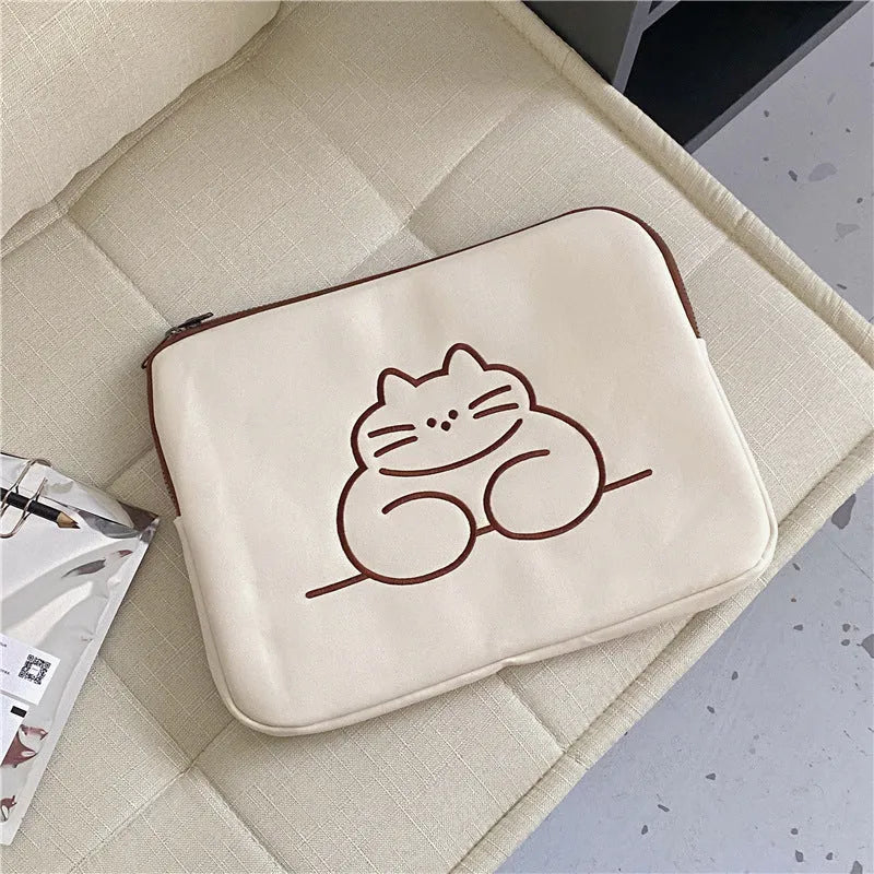 Embroidered fat cat design on a grey nylon tablet protective sleeve with a black zipper.