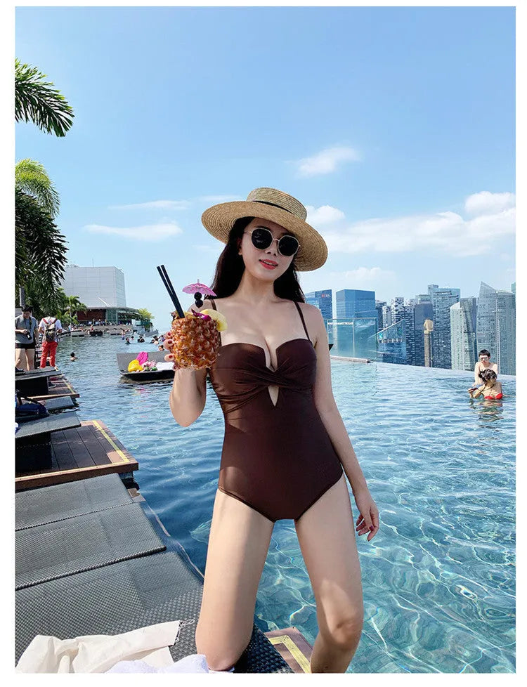 A solid colour one-piece swimsuit for women with spaghetti straps, shown in white.