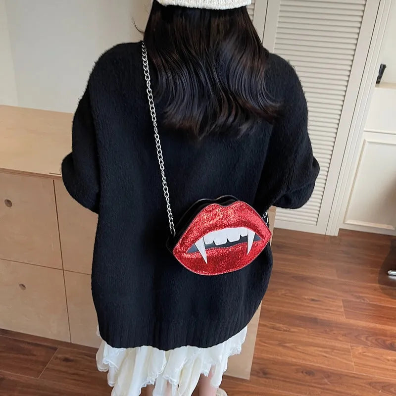 Small red PU sequin crossbody bag with chain detail, oval hard shape, front view on plain background