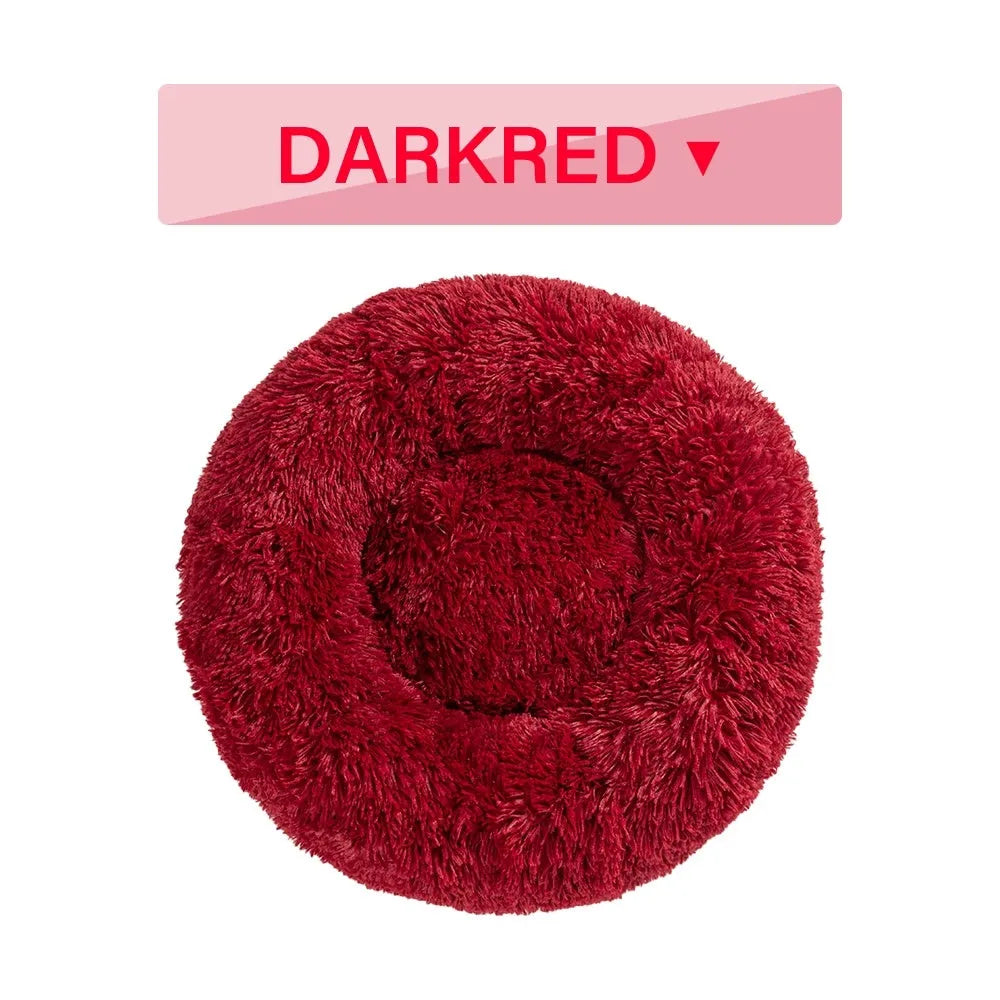 Fluffy donut-shaped pet bed in long plush fabric, showing raised rim, available in multiple colours.