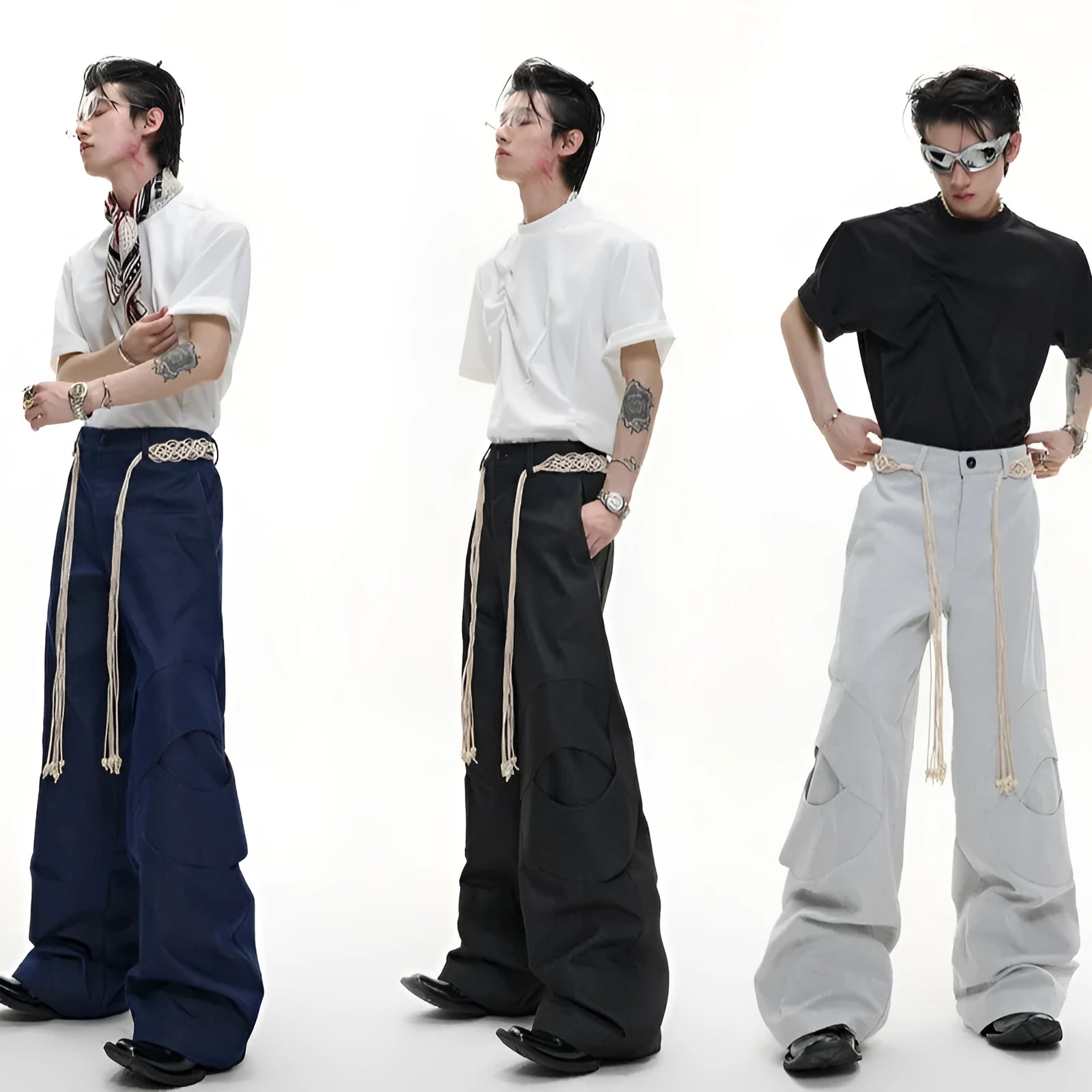 Men's dark blue straight-leg jeans showing loose fit, belt stitching with tassel, and zip pocket decorations.