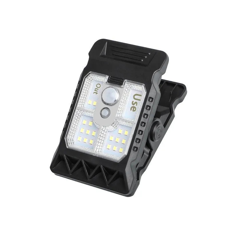 White intelligent motion sensor clip lamp mounted on a shelf edge.