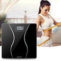 Black electronic digital bathroom scale on a floor showing a maximum capacity of 180 kg.