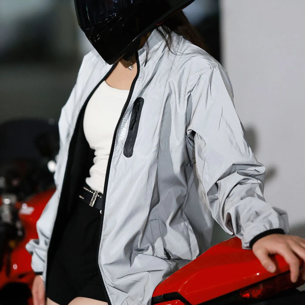 Silver waterproof polyester long sleeved jacket showing front view with size label indicating Asian and European conversion