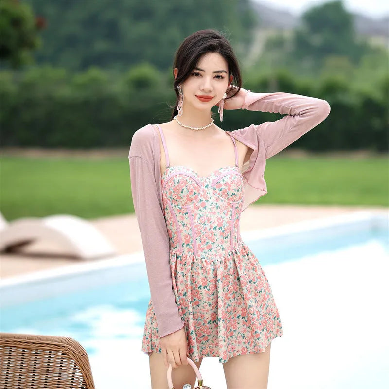 Women's pink floral jumpsuit swimsuit with adjustable suspender straps on mannequin