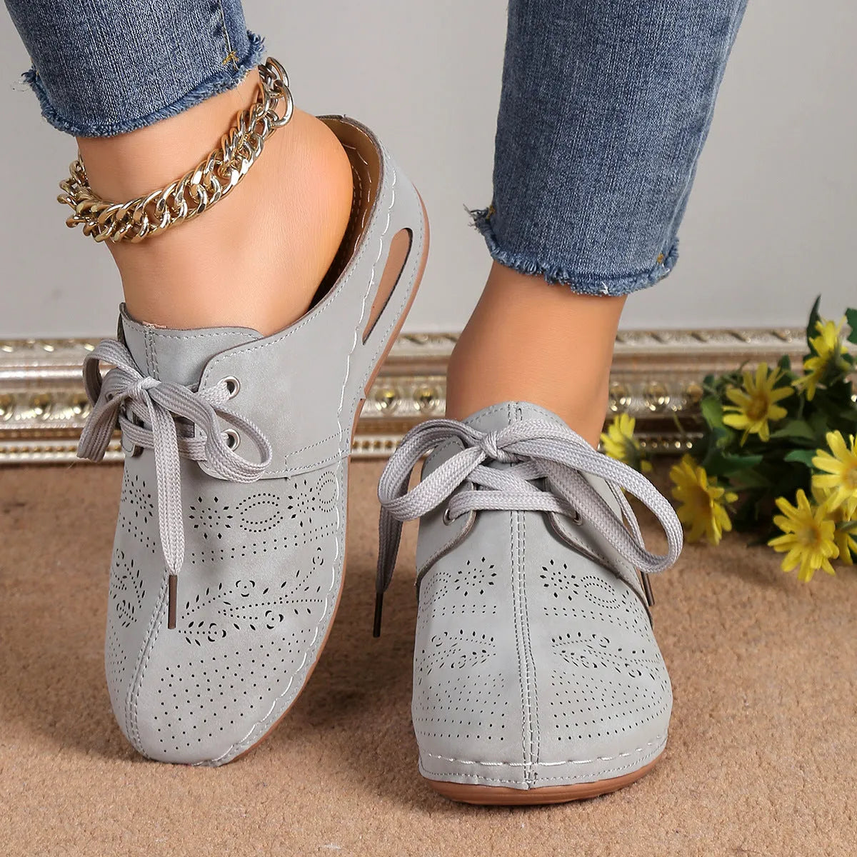 Women's black suede lace-up wedge slippers with hollow-out design and rubber sole.
