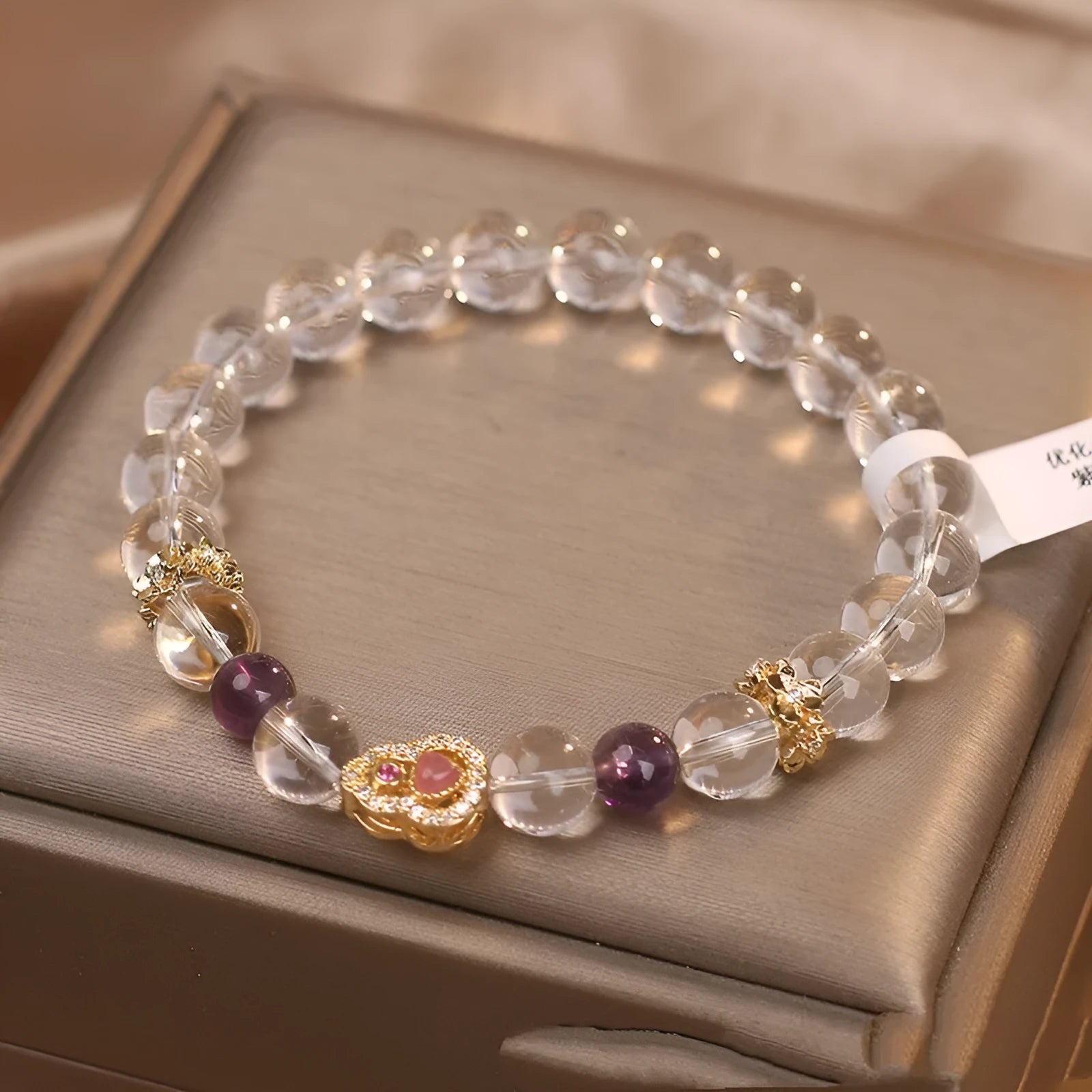 Natural white crystal bracelet for women with transparent gourd detail on light background