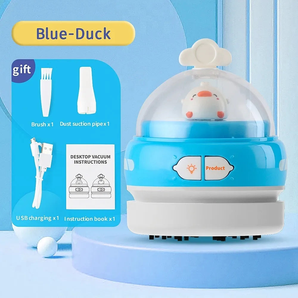 Blue rocket-shaped USB rechargeable handheld desktop vacuum cleaner on a wooden desk next to a keyboard