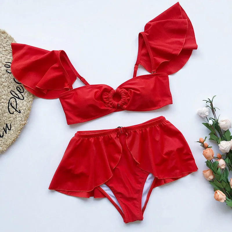 Women's red three-piece flounced bikini set with ruffled bandeau top, high-waisted briefs, and sarong skirt