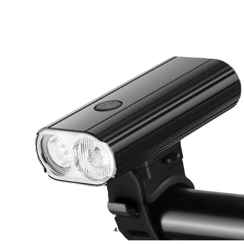 Aluminium bicycle headlight with twin LED bulbs and quick release mount showing USB Type-C charging port