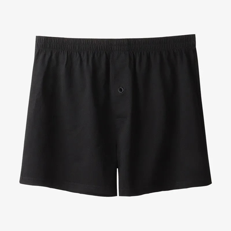 Men's solid colour cotton boxer shorts on a hanger, showing loose fit and high waist.