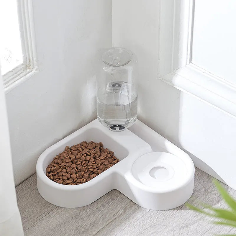 White plastic pet water fountain with electric pump on a floor.