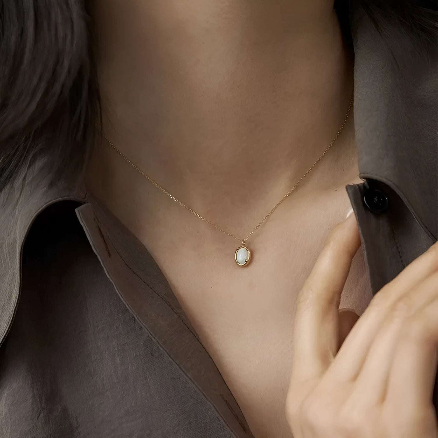 Oval jelly opal geometric pendant on a sterling silver chain with gold plating.