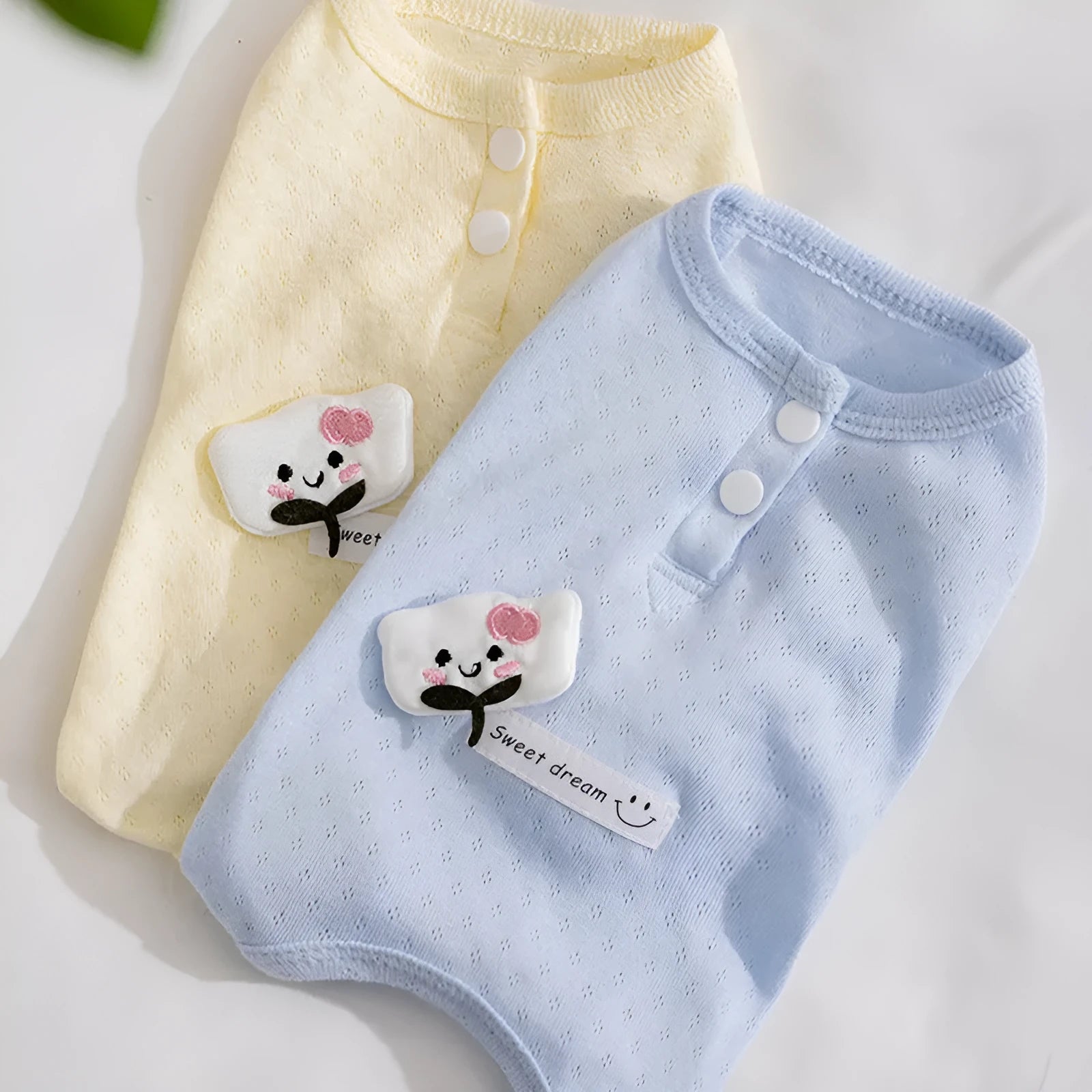 Pet shirt in soft yellow mesh fabric with cat patches and button closure on white background
