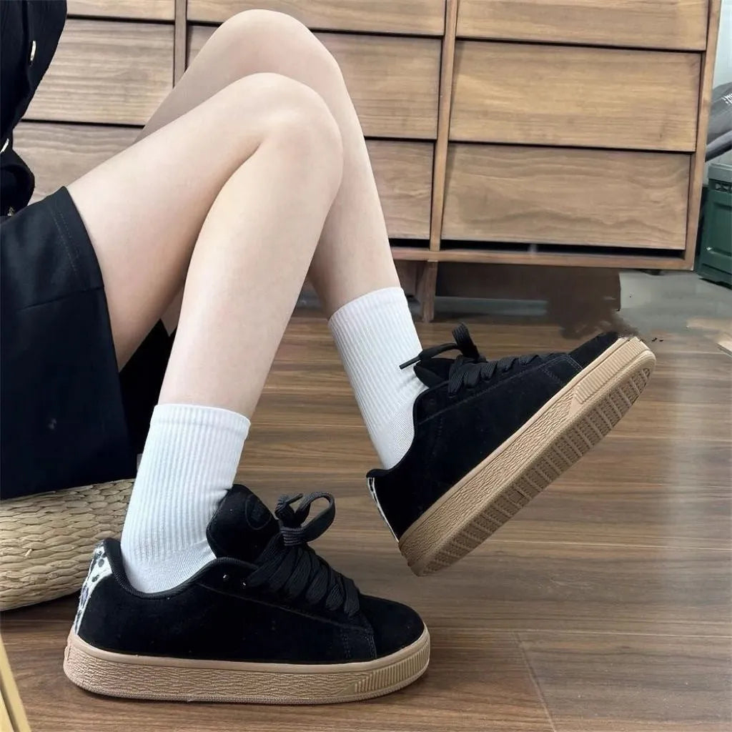 Black retro low-top sneakers with waterproof platform sole and round toe design