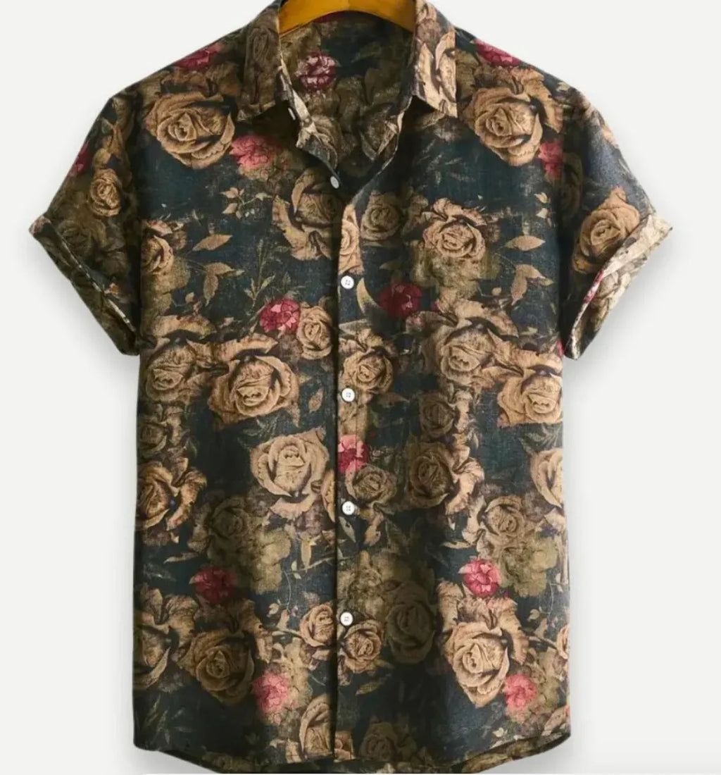 A man wearing a short sleeve floral print Hawaiian shirt with a button-up front and lapel collar.