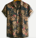A man wearing a short sleeve floral print Hawaiian shirt with a button-up front and lapel collar.