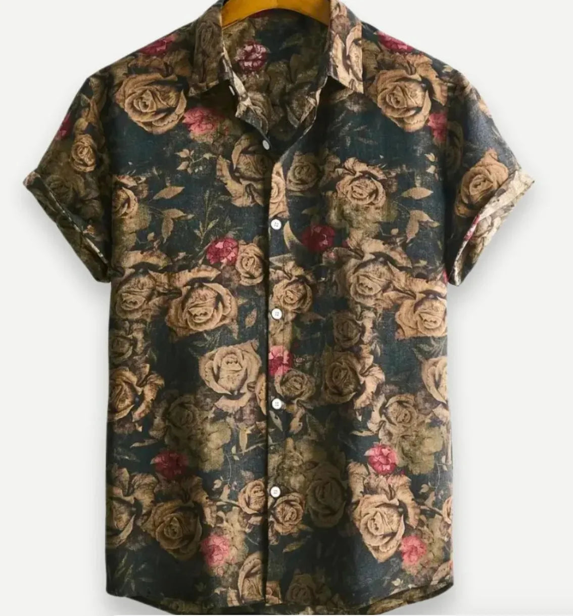 A man wearing a short sleeve floral print Hawaiian shirt with a button-up front and lapel collar.