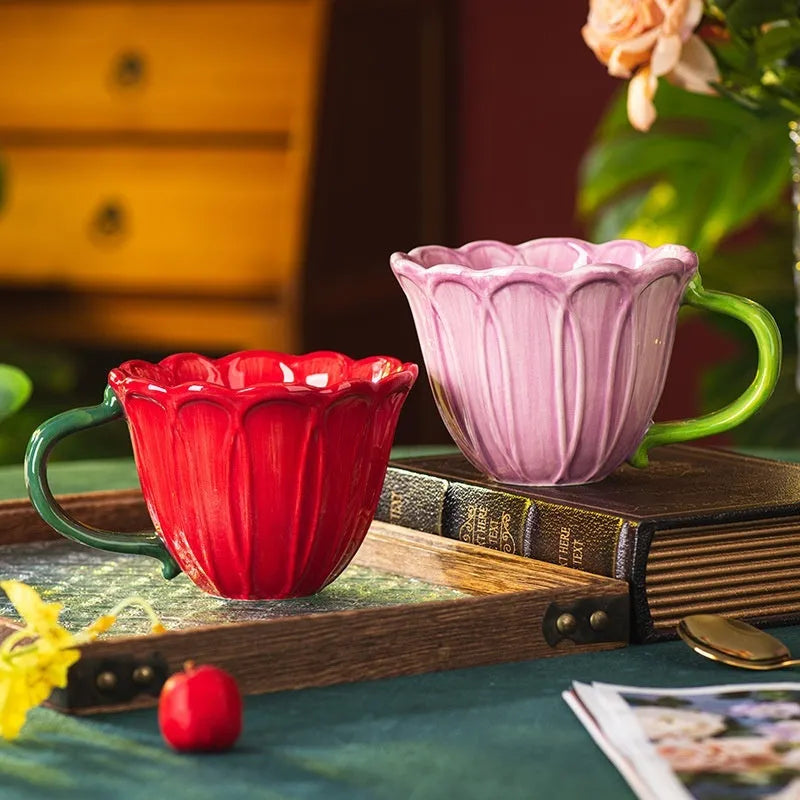 A red and purple floral ceramic cup with a 500ml capacity on a wooden table.